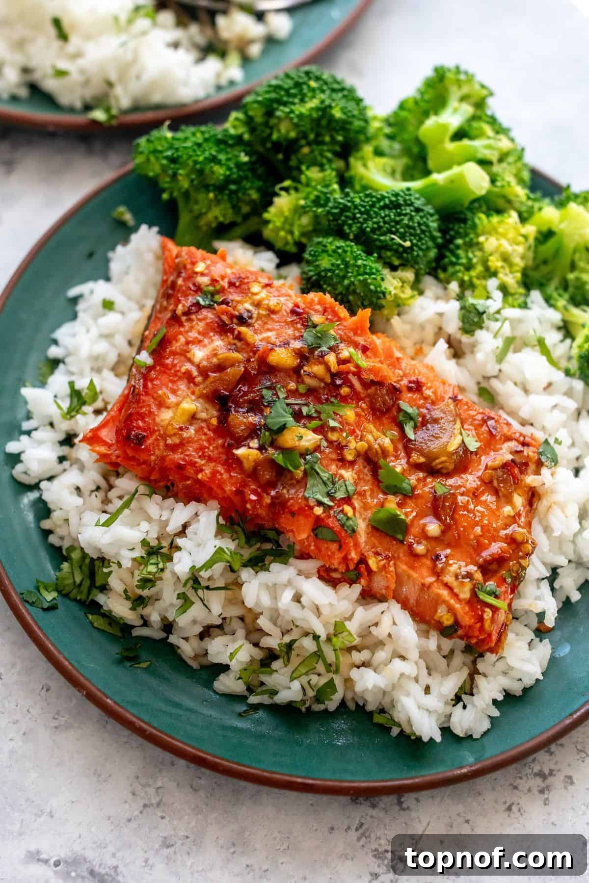 Blazing Sweet Chili Salmon 2 green plate with firecracker salmon on top and broccoli.