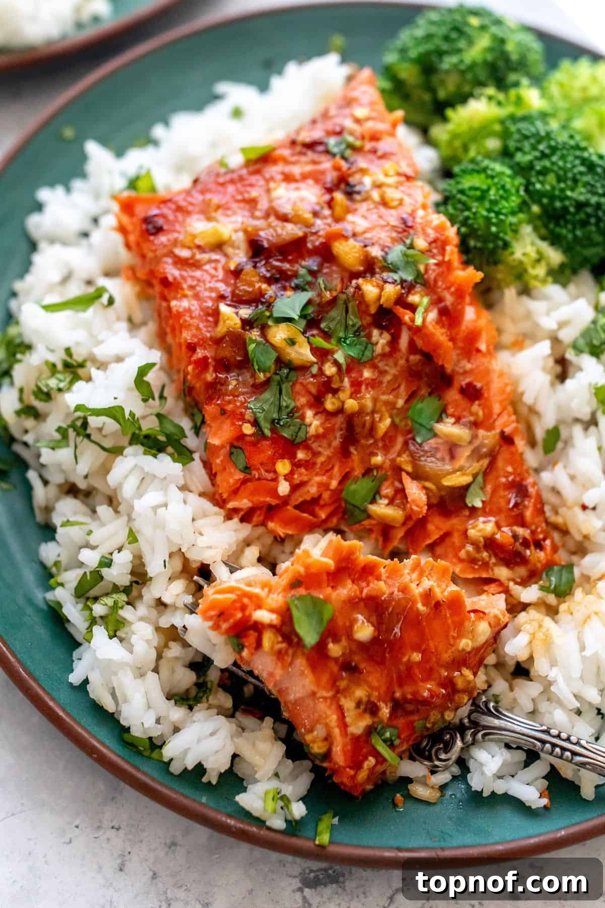 Blazing Sweet Chili Salmon 5 green plate with firecracker salmon on top and broccoli.