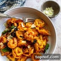 Shrimp Tortellini (Fra Diavolo) dish in a rustic setting.