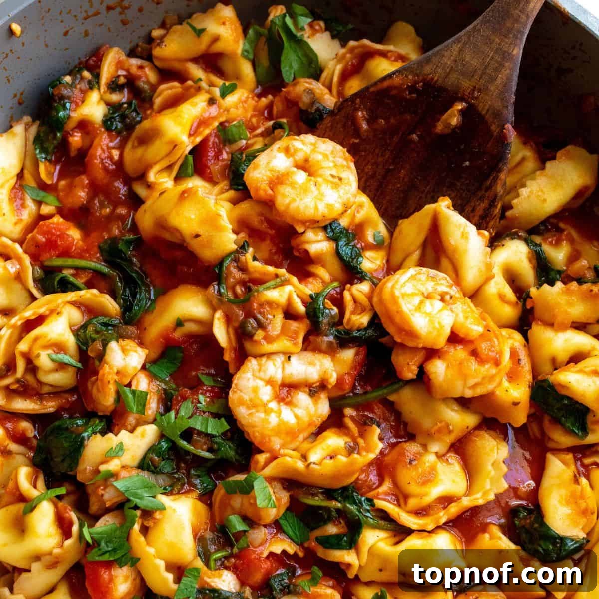 Fra Diavolo Shrimp Tortellini 5 A close-up view of spicy shrimp tortellini Fra Diavolo simmering in a large skillet, ready to be served.