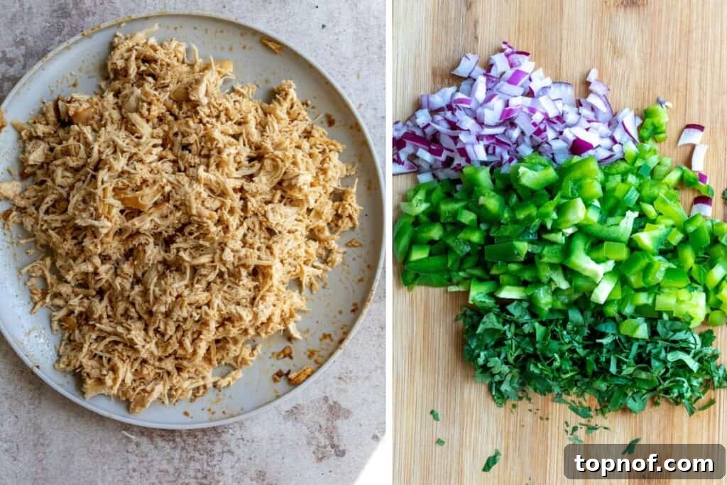 Golden Crisp Chicken Taquitos 4 Shredded cooked chicken breast in a large bowl, surrounded by ingredients like bell peppers, onions, and cream cheese, ready to be mixed for the taquito filling.