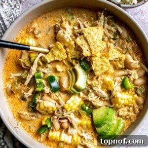 White Bean Chili With Chicken in a serving bowl with toppings.