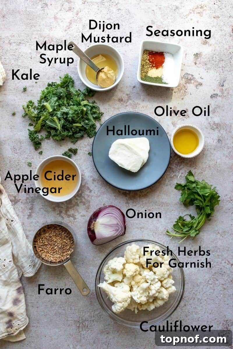 Farro Bowl Ingredients Array of fresh ingredients including farro, cauliflower, kale, onion, and dressing components, laid out on a counter.