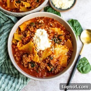 A comforting bowl of One Pot Lasagna Soup with tender noodles and a golden spoon on the side, ready to be enjoyed.