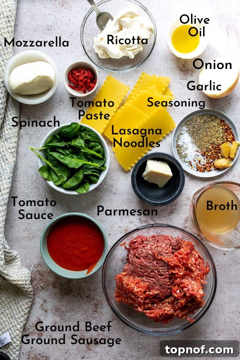 Skillet Lasagna Comfort 3 Assortment of fresh ingredients for One Pot Lasagna Soup, including ground meats, onions, garlic, tomato products, and cheeses, laid out on a kitchen counter.