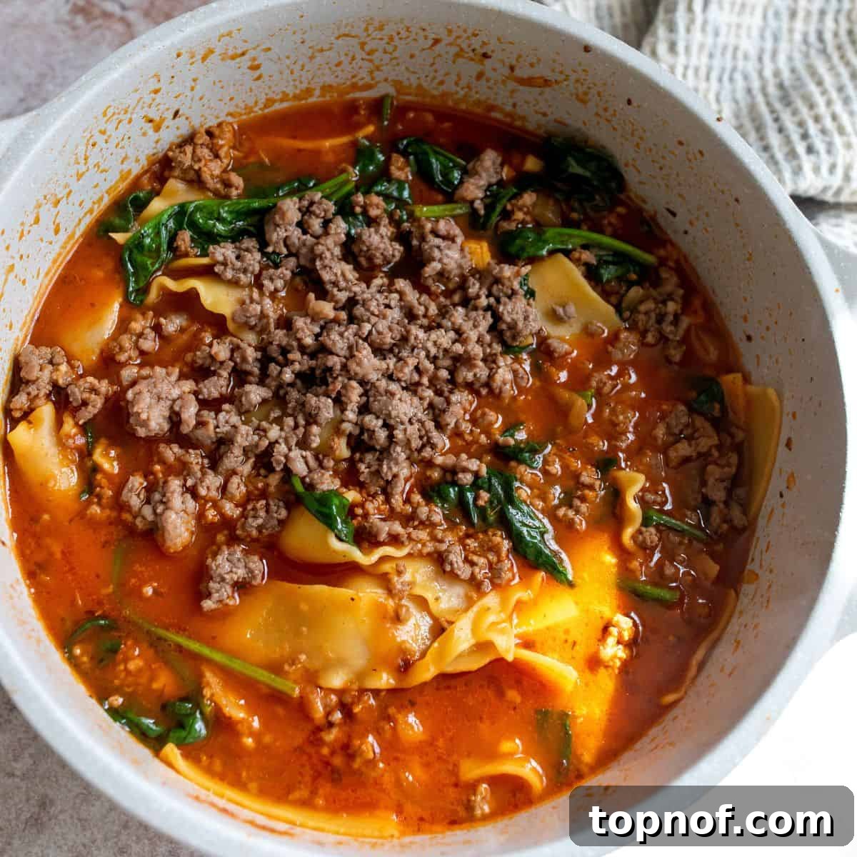 Skillet Lasagna Comfort 5 The One Pot Lasagna Soup simmering in a large Dutch oven, filled with robust tomato broth, ground meat, and broken lasagna noodles.