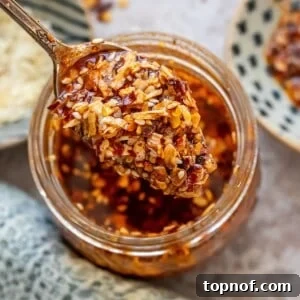 Chili onion crunch in a jar with a spoon.
