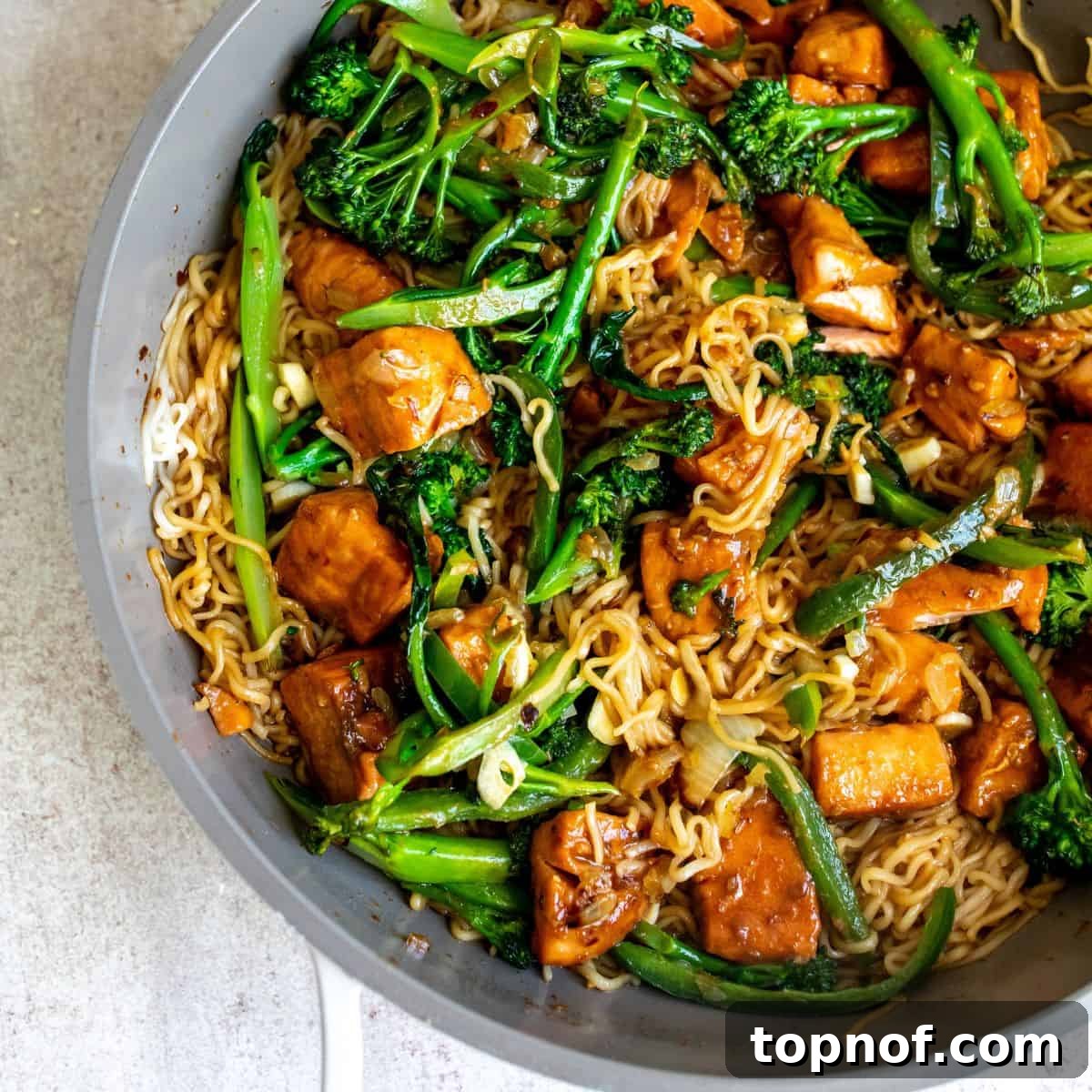 Savory Teriyaki Salmon Noodle Bowl 6 Finished Teriyaki Salmon Noodles, vibrant and saucy, presented directly in the sauté pan before serving.