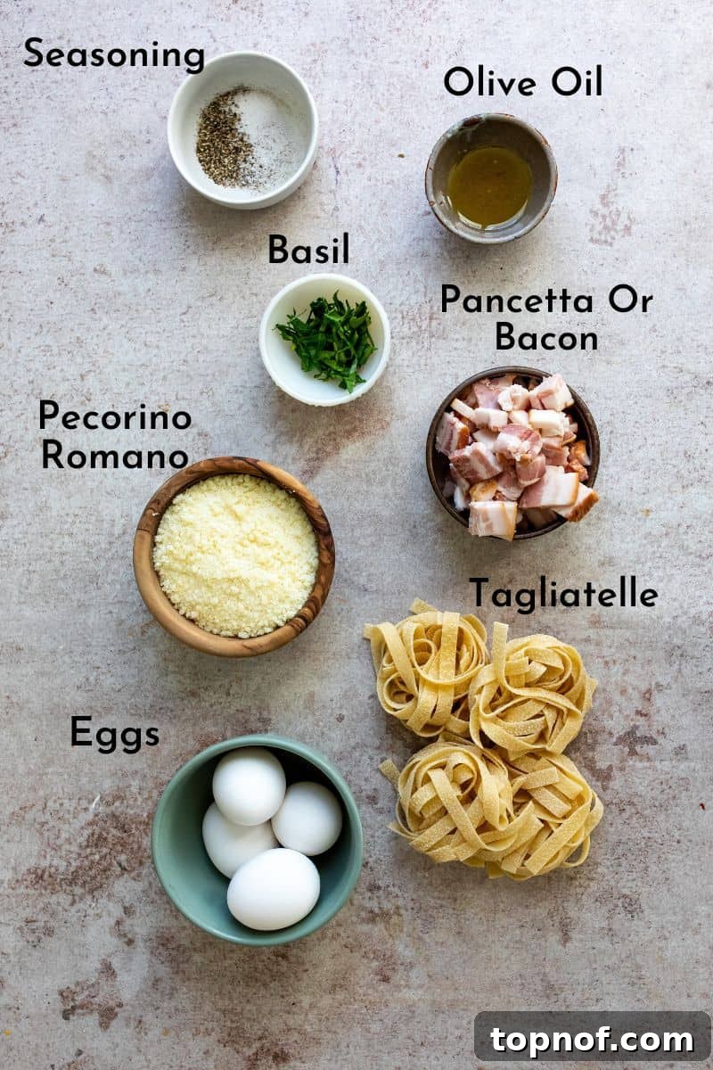 Creamy Carbonara with Crispy Pancetta 3 Ingredients for Tagliatelle Carbonara laid out on a kitchen counter in small bowls, including pasta, eggs, pancetta, and cheese.
