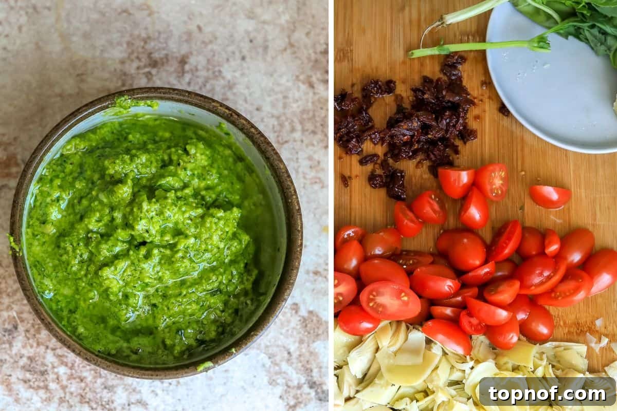 Mediterranean Tuna Pesto Pasta 4 A vibrant bowl of freshly blended spinach walnut pesto sitting beside a cutting board with neatly chopped cherry tomatoes, sun-dried tomatoes, and artichoke hearts, all ready for the pasta dish.