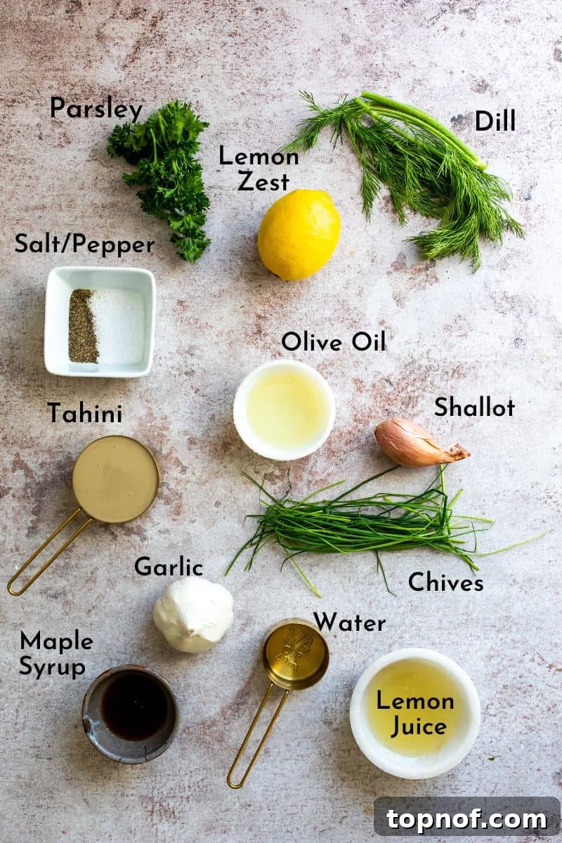 Vibrant Lemon Herb Tahini Sauce 3 A selection of fresh ingredients including tahini, lemons, herbs, garlic, and olive oil, ready for making dressing.