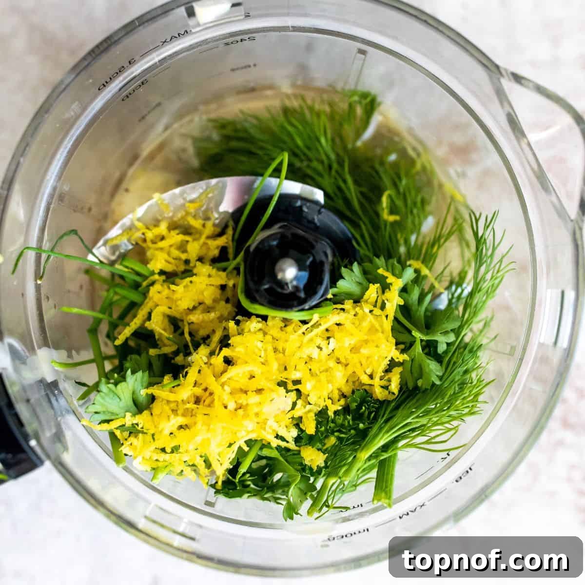 Vibrant Lemon Herb Tahini Sauce 4 A high-speed blender containing all the fresh ingredients for the lemon herb tahini dressing, ready to be blended.