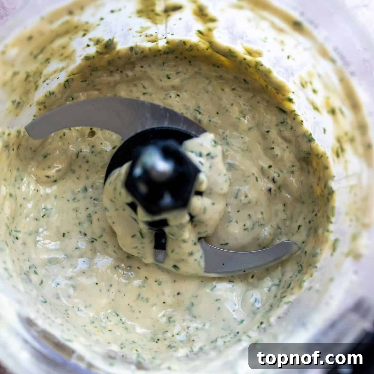 Vibrant Lemon Herb Tahini Sauce 5 Close-up of the smooth, creamy lemon herb tahini dressing inside a blender.