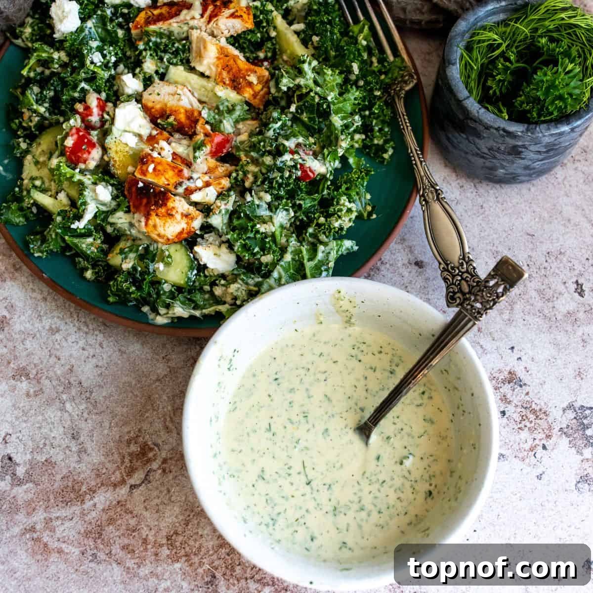 Vibrant Lemon Herb Tahini Sauce 6 A vibrant kale salad topped with blackened chicken and vegetables, drizzled with the homemade lemon herb tahini dressing.
