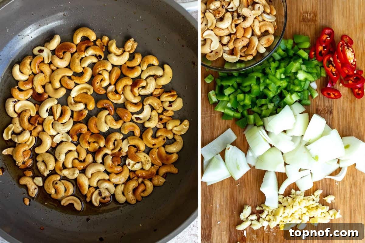 Classic Thai Cashew Chicken 4 Raw cashews being toasted in a black skillet next to a cutting board with freshly chopped garlic, onions, and peppers, all ready for cooking.