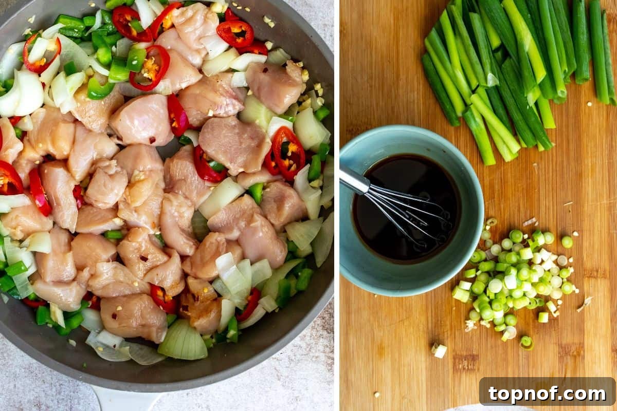 Classic Thai Cashew Chicken 5 Chicken and a medley of vibrant vegetables simmering in a grey skillet, with a small bowl of the prepared sauce and chopped green onions on a nearby cutting board.
