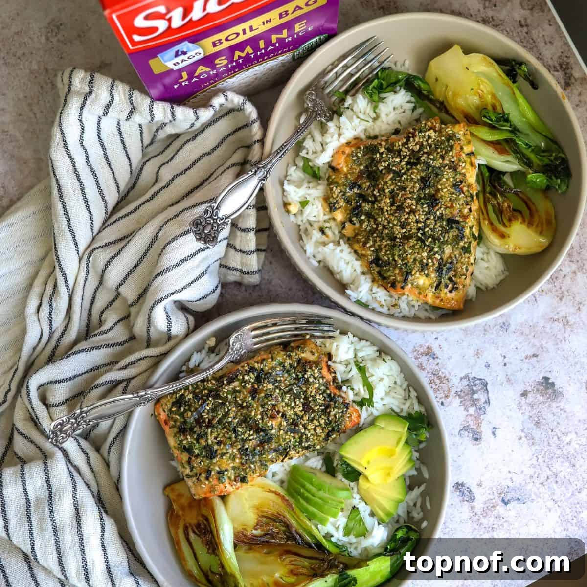 Savory Furikake Crusted Salmon 2 Furikake Salmon served on white rice in a bowl, garnished with avocado slices and a fork.