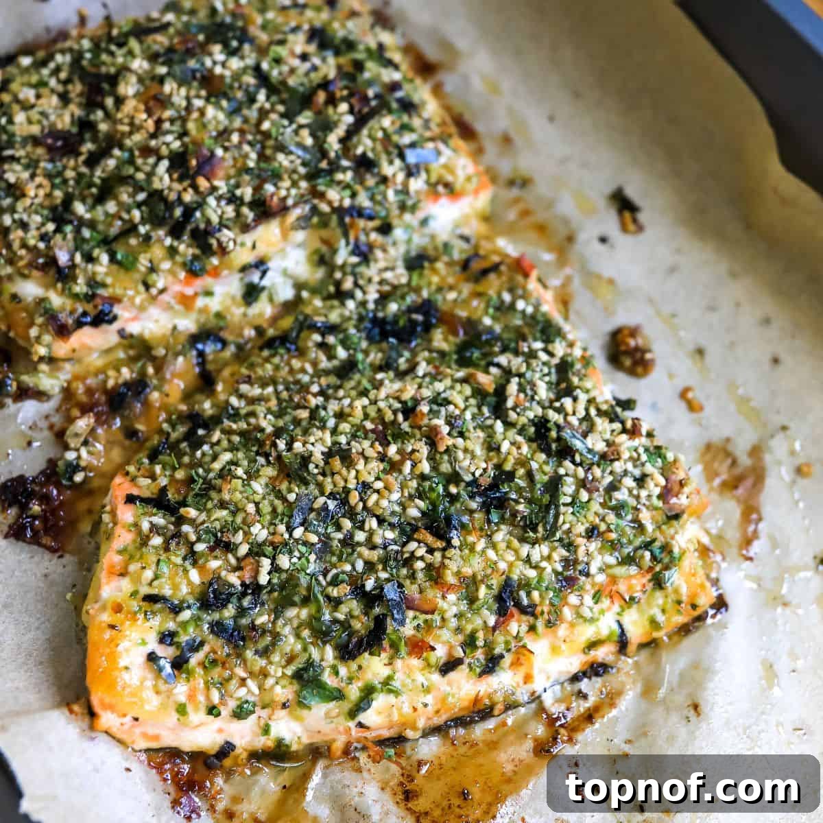 Savory Furikake Crusted Salmon 7 Close-up of a perfectly cooked salmon fillet with vibrant Furikake seasoning, resting on parchment paper.