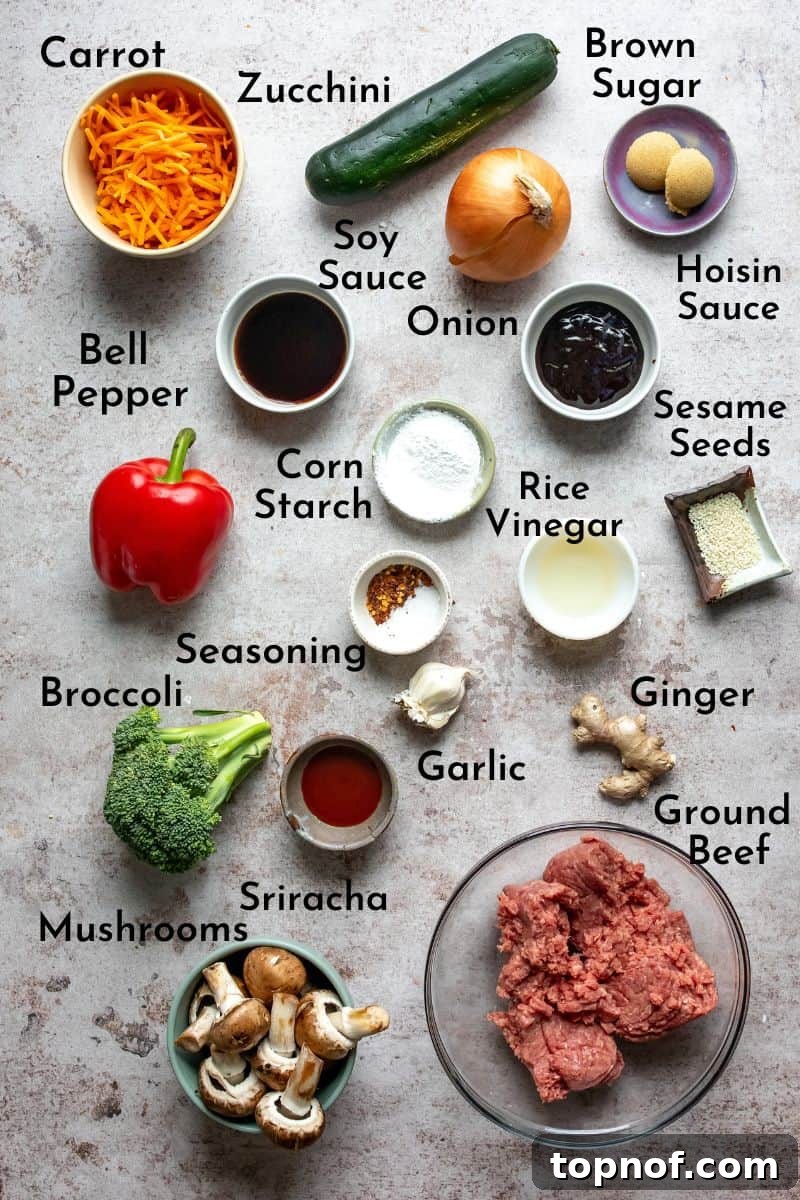 Savory Ground Beef Stir Fry 3 Fresh ingredients laid out on a wooden cutting board: lean ground beef, various chopped vegetables, and sauce components.