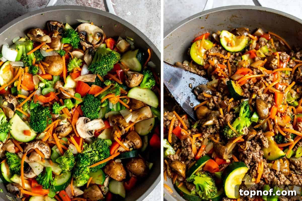 Savory Ground Beef Stir Fry 5 Grey skillet filled with cooked vegetables and browned ground beef, with a wooden spatula resting in it.