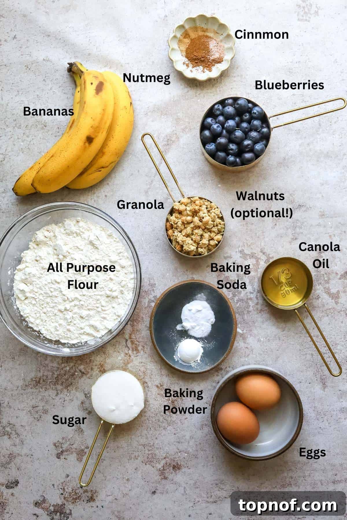 Ultimate Blueberry Banana Nut Bread 3 Small bowls containing all the fresh ingredients needed to bake this delicious banana blueberry bread recipe, neatly arranged on a kitchen counter.