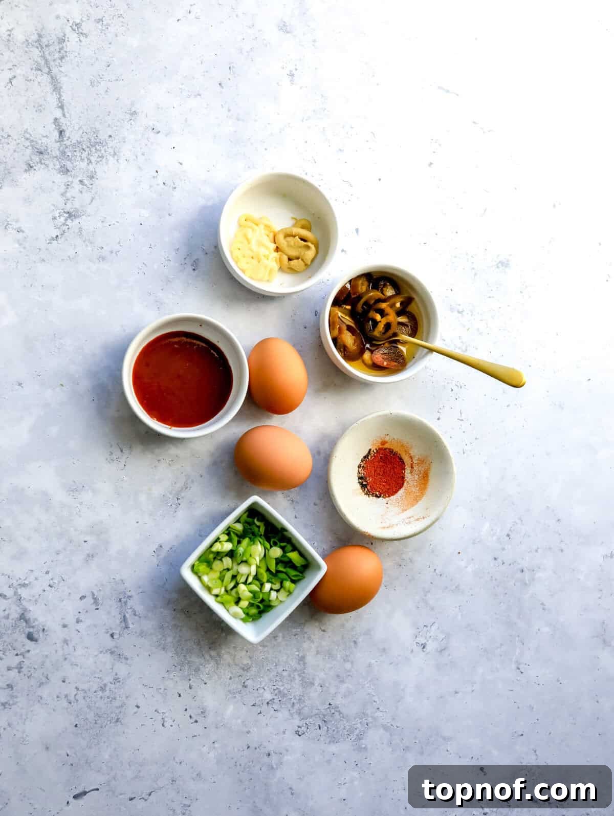 Fiery Deviled Delights 3 Array of fresh ingredients on a kitchen countertop, ready for making spicy deviled eggs.