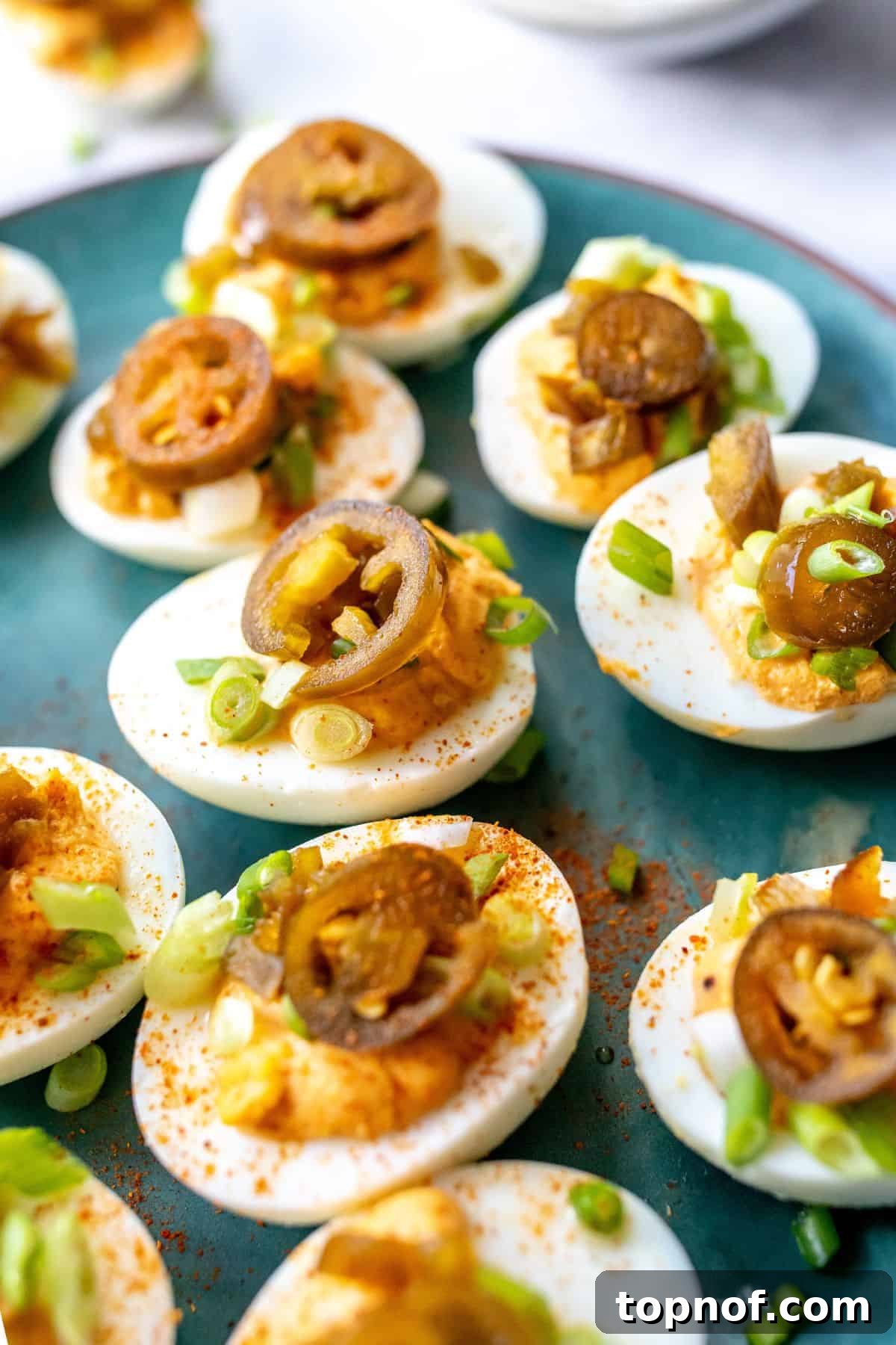 Fiery Deviled Delights 6 Close-up of freshly made spicy deviled eggs, garnished and ready to serve.