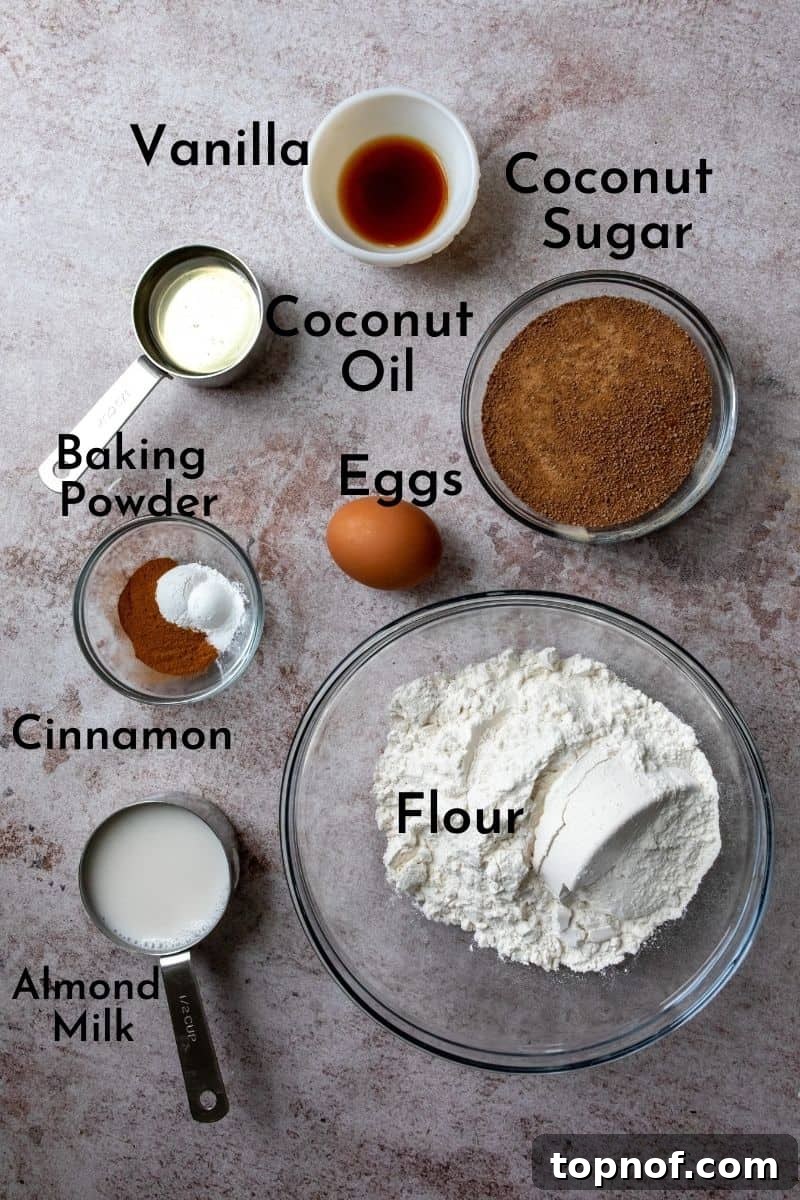 Sweet Cinnamon Loaf 3 Ingredients for homemade cinnamon sugar bread arranged in various bowls on a rustic kitchen counter.