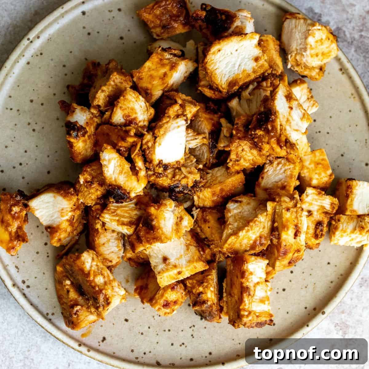 Vibrant Tikka Chicken Salad 6 Cooked marinated chicken tikka pieces in a large skillet, still sizzling.
