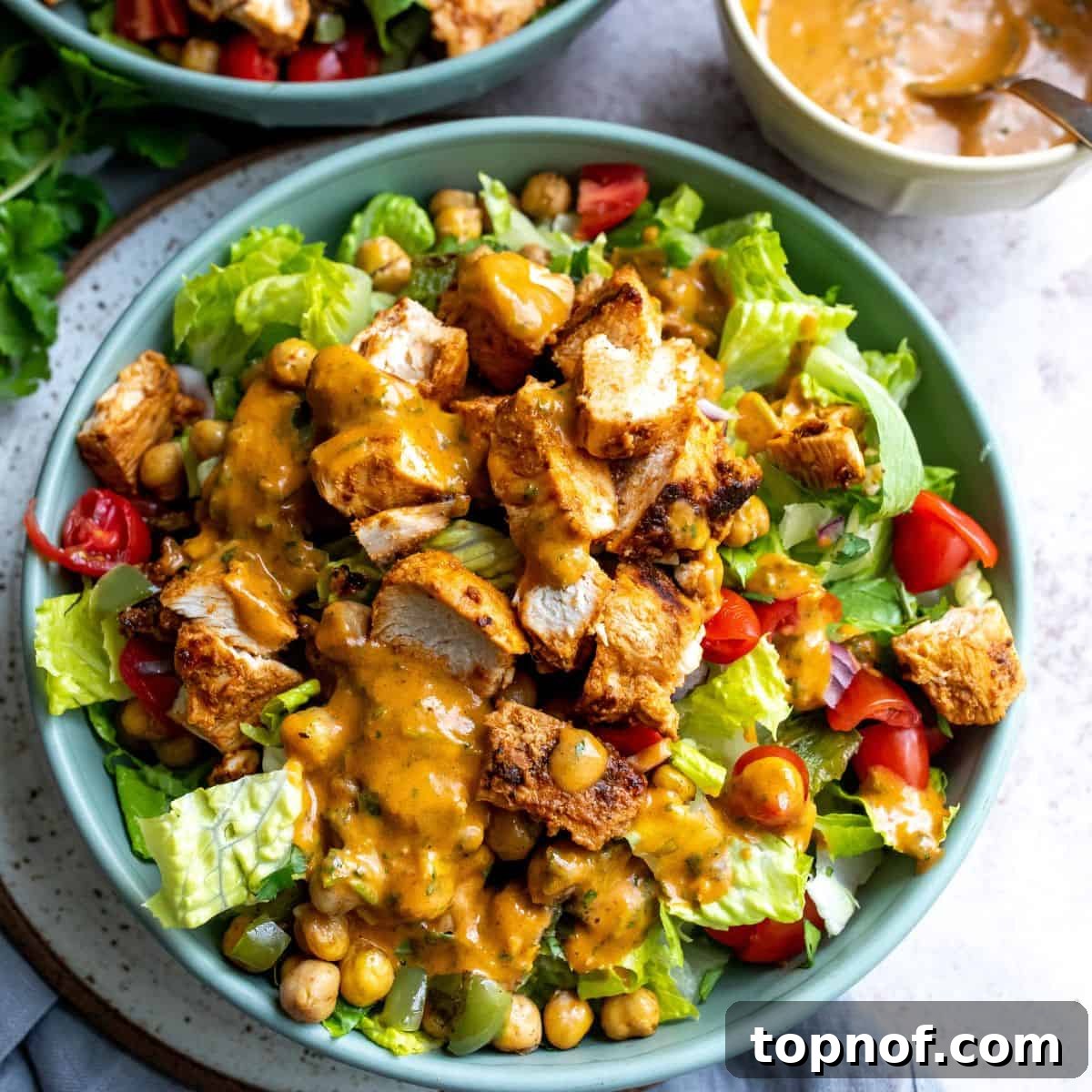 Vibrant Tikka Chicken Salad 7 A vibrant and fresh Chicken Tikka Salad assembled in a blue bowl with a fork ready to enjoy.
