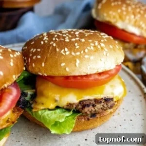 Close-up of a perfectly cooked Turkey Smash Burger on a white plate.