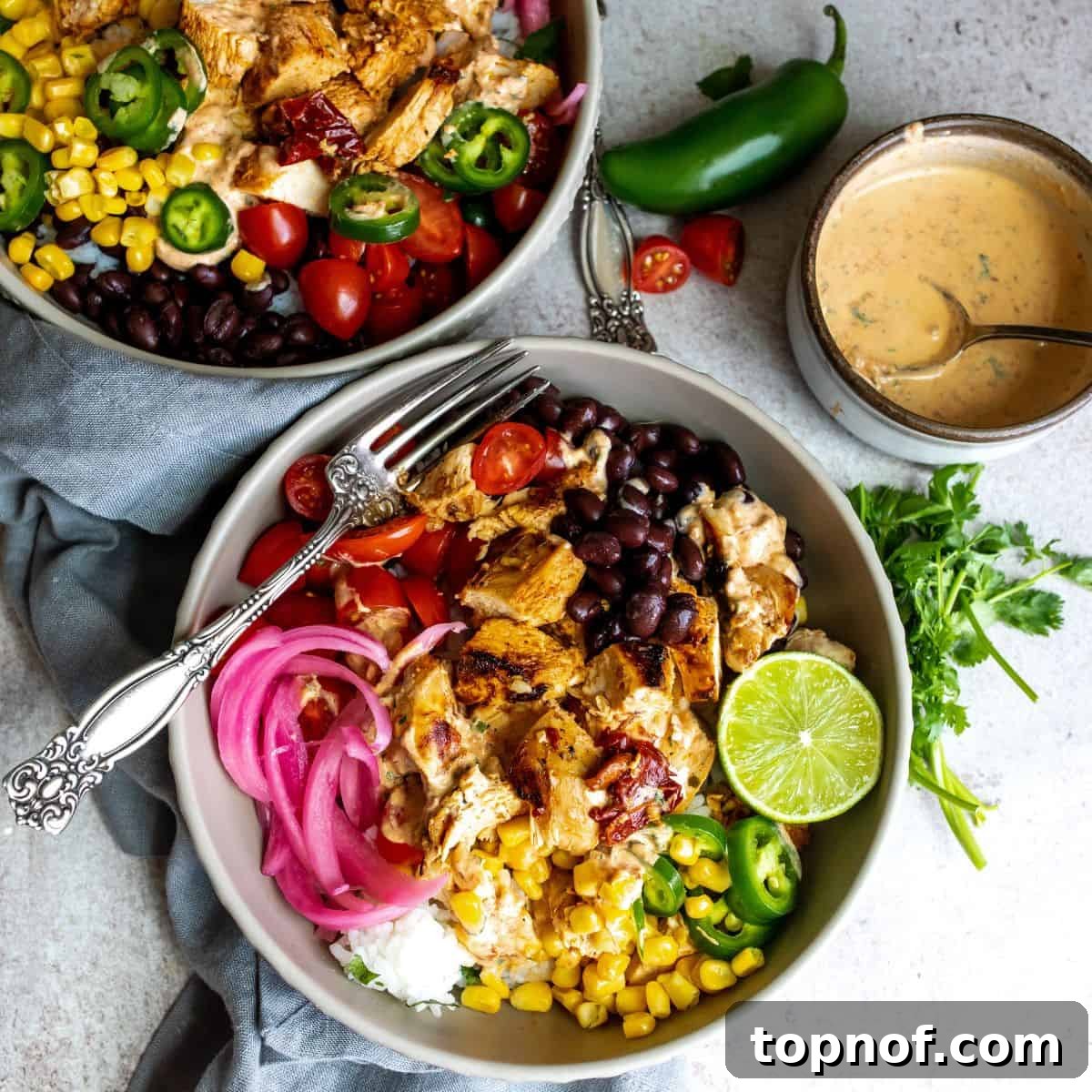 Chipotle Chicken Fiesta Bowl 2 Chipotle Chicken Bowls on a white counter, vibrant and ready to eat.