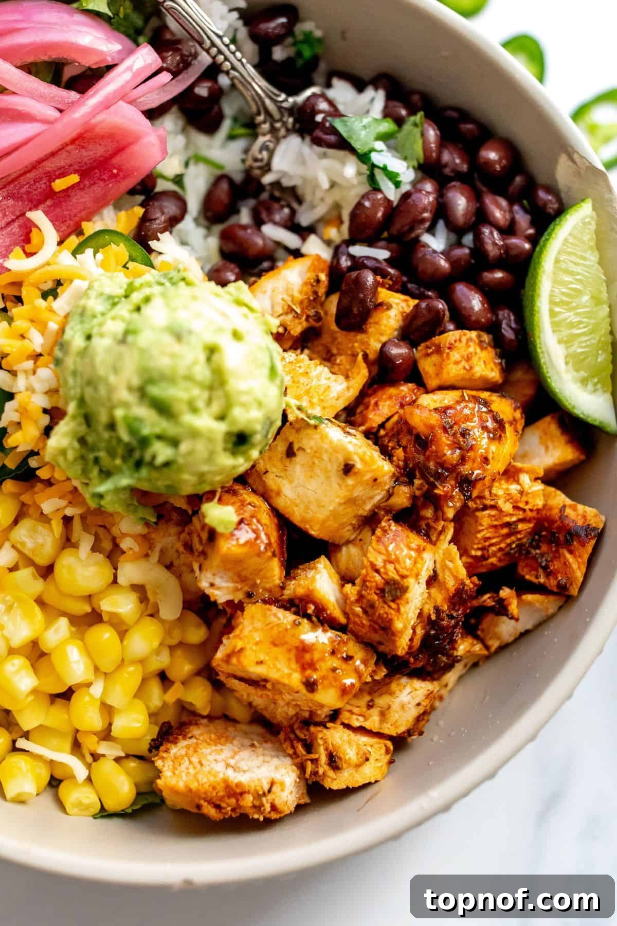 Chipotle Chicken Fiesta Bowl 6 Close-up of a Chipotle Chicken Bowl with guacamole, showing rich textures.