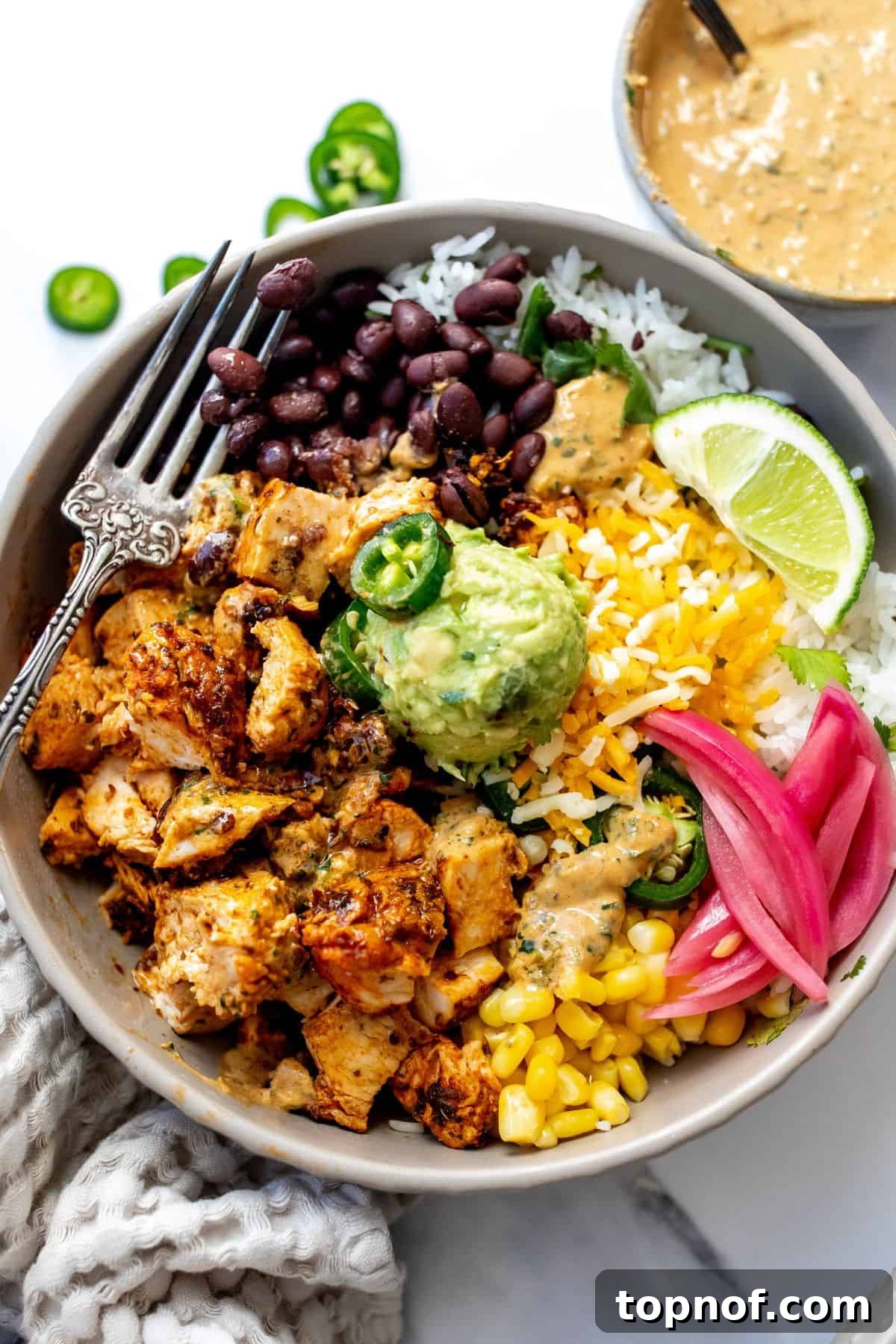 Chipotle Chicken Fiesta Bowl 7 A beautifully assembled Chipotle Chicken Bowl in a grey bowl, ready to be enjoyed.