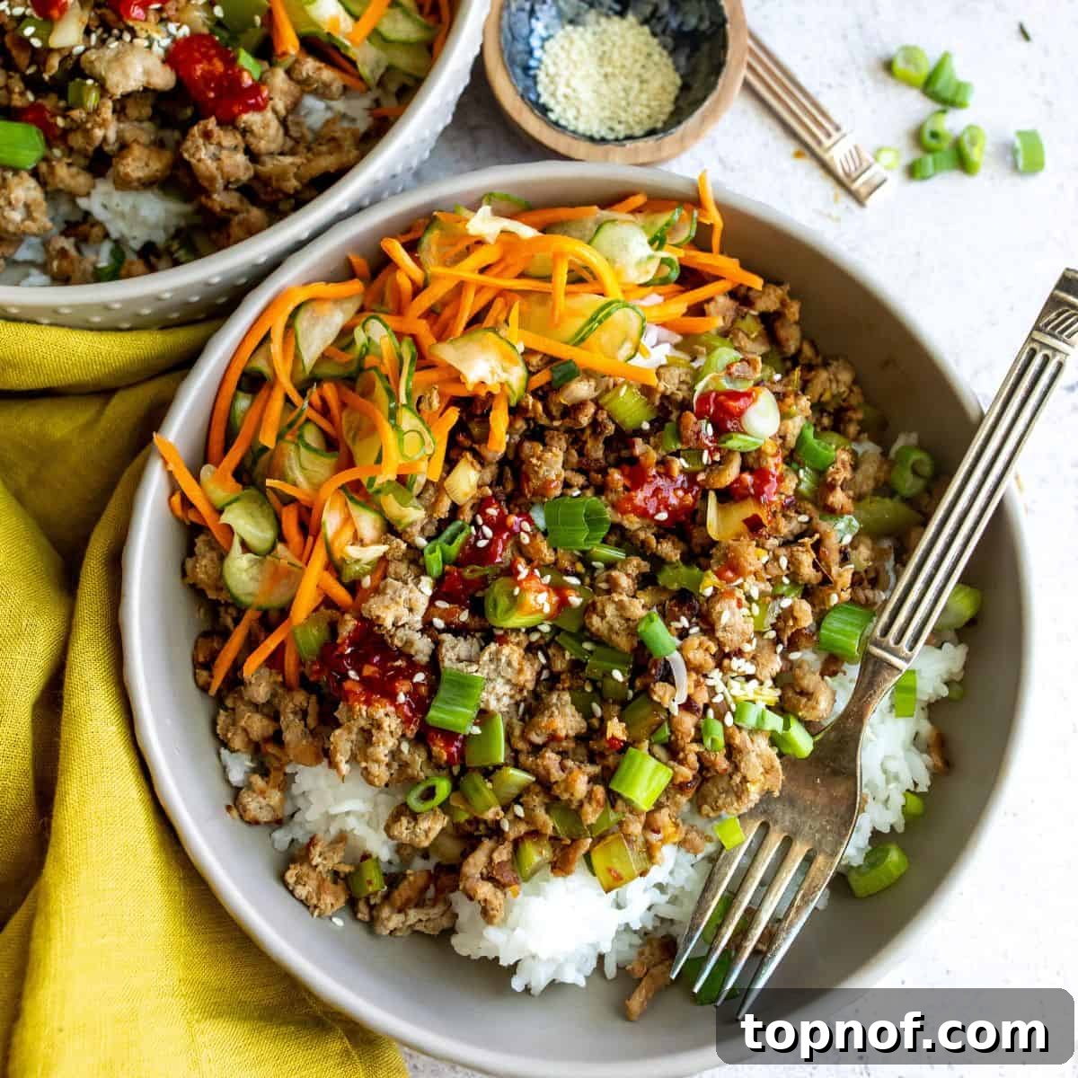 Sweet & Spicy Korean Ground Turkey 6 Close-up of a grey bowl with Korean ground turkey, rice, and fresh veggies.