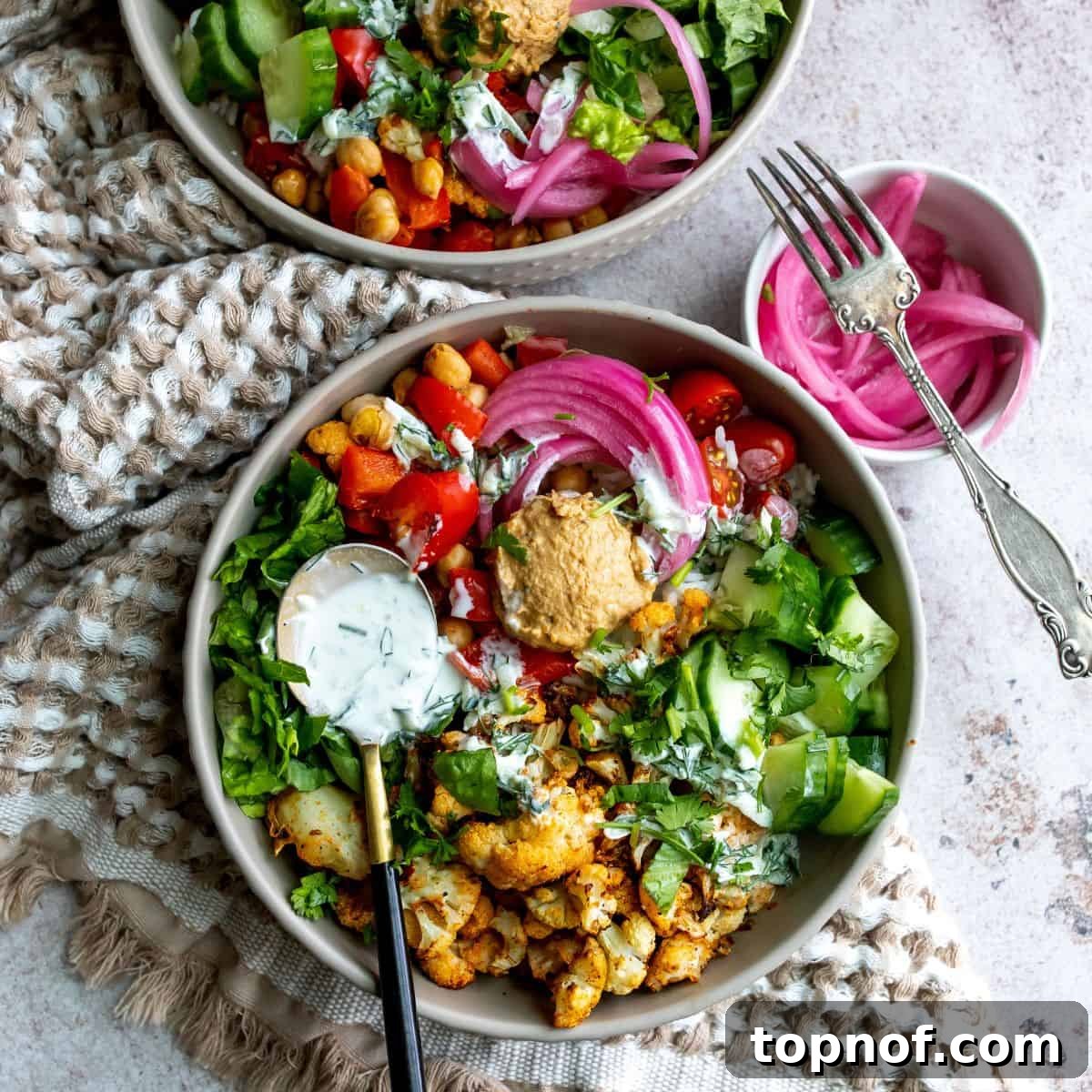 Plant Powered Shawarma 2 Veggies spiced and in a grey bowl with a spoon full of sauce.