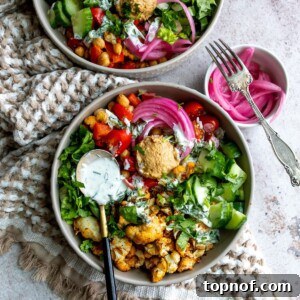 Gray bowls with spiced veggies and tzatziki sauce
