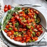 Tomato Relish in a large serving bowl with a silver serving spoon.