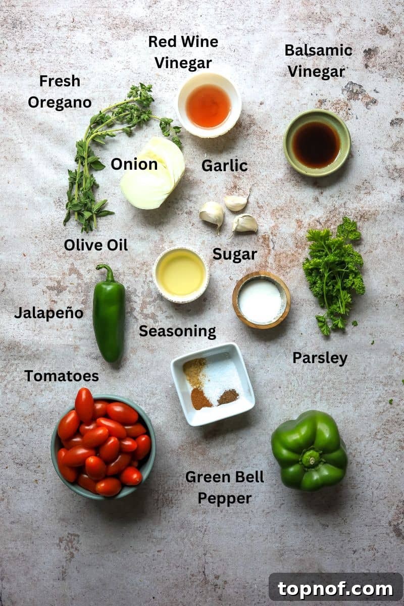 Sun-Kissed Tomato Condiment 3 All the fresh ingredients needed to make this tomato relish recipe laid out on a kitchen counter in small bowls, including cherry tomatoes, bell pepper, and fresh herbs.