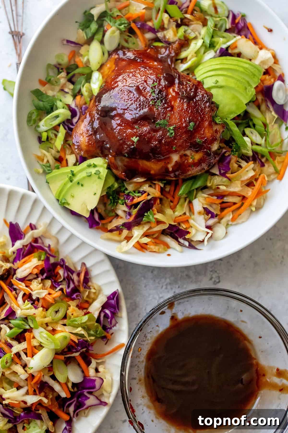 Glazed BBQ Chicken Thighs 6 Close-up of a delicious grain bowl featuring oven-baked BBQ chicken thighs.