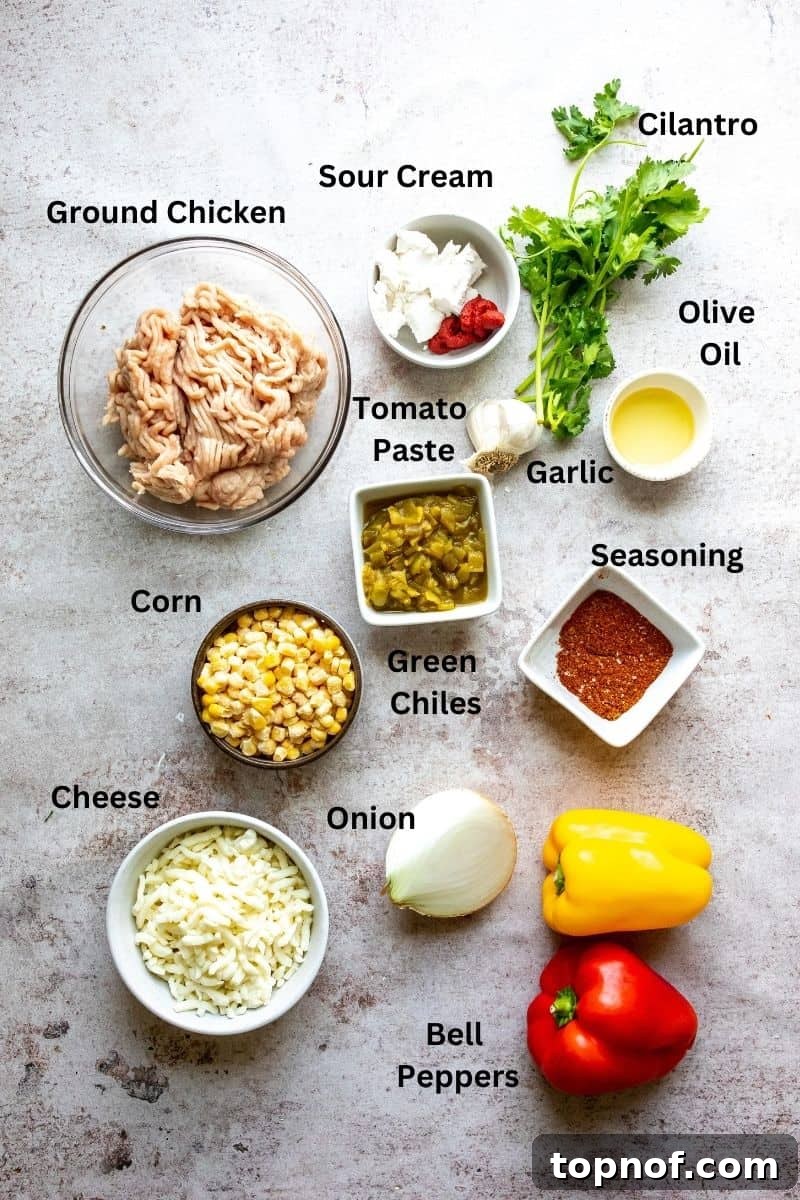 Flavorful Chicken Stuffed Bell Peppers 3 Ingredients needed to make ground turkey stuffed peppers on a counter in small bowls and plates, including spices, corn, chilies, and cheese.