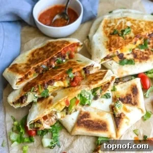 Black bean crunch wraps on parchment on a counter with salsa.