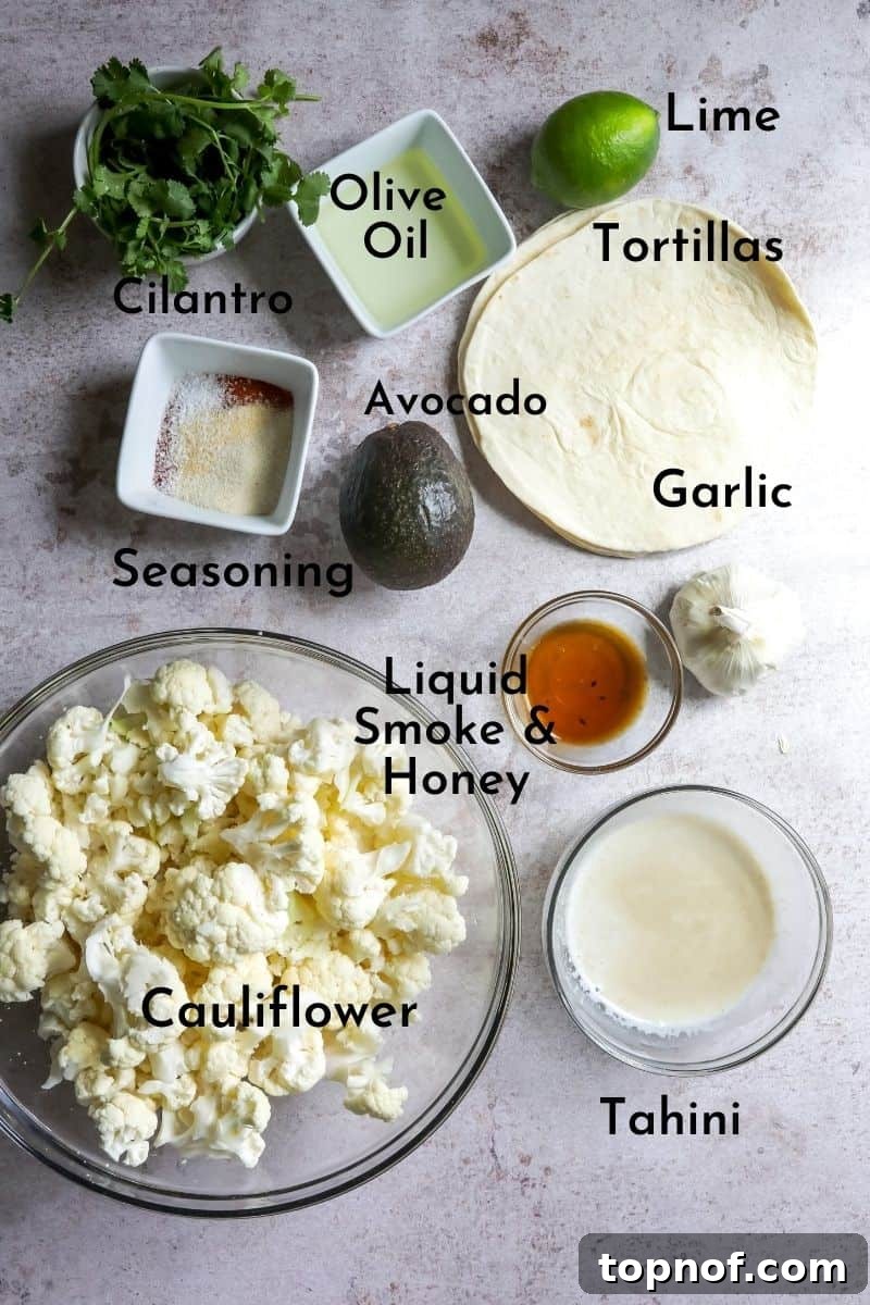 A selection of fresh ingredients, including a head of cauliflower and spices, laid out for preparing the taco recipe.