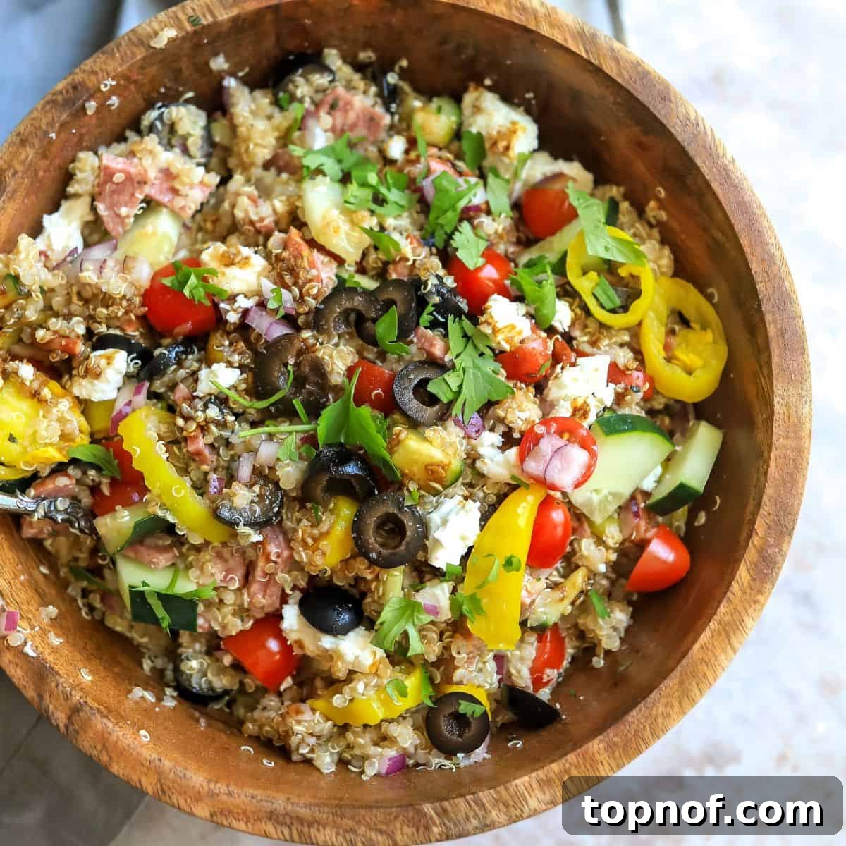 Tuscan Quinoa Medley 5 Large wooden bowl with Italian quinoa salad and fresh veggies, ready to be served, highlighting its generous portion.