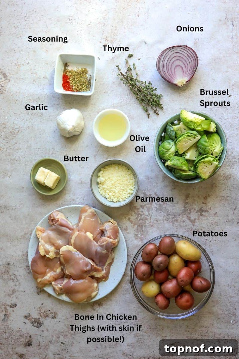 Various ingredients for slow cooker garlic parmesan chicken laid out in small bowls on a kitchen counter, including chicken thighs, potatoes, Brussels sprouts, garlic, and spices.