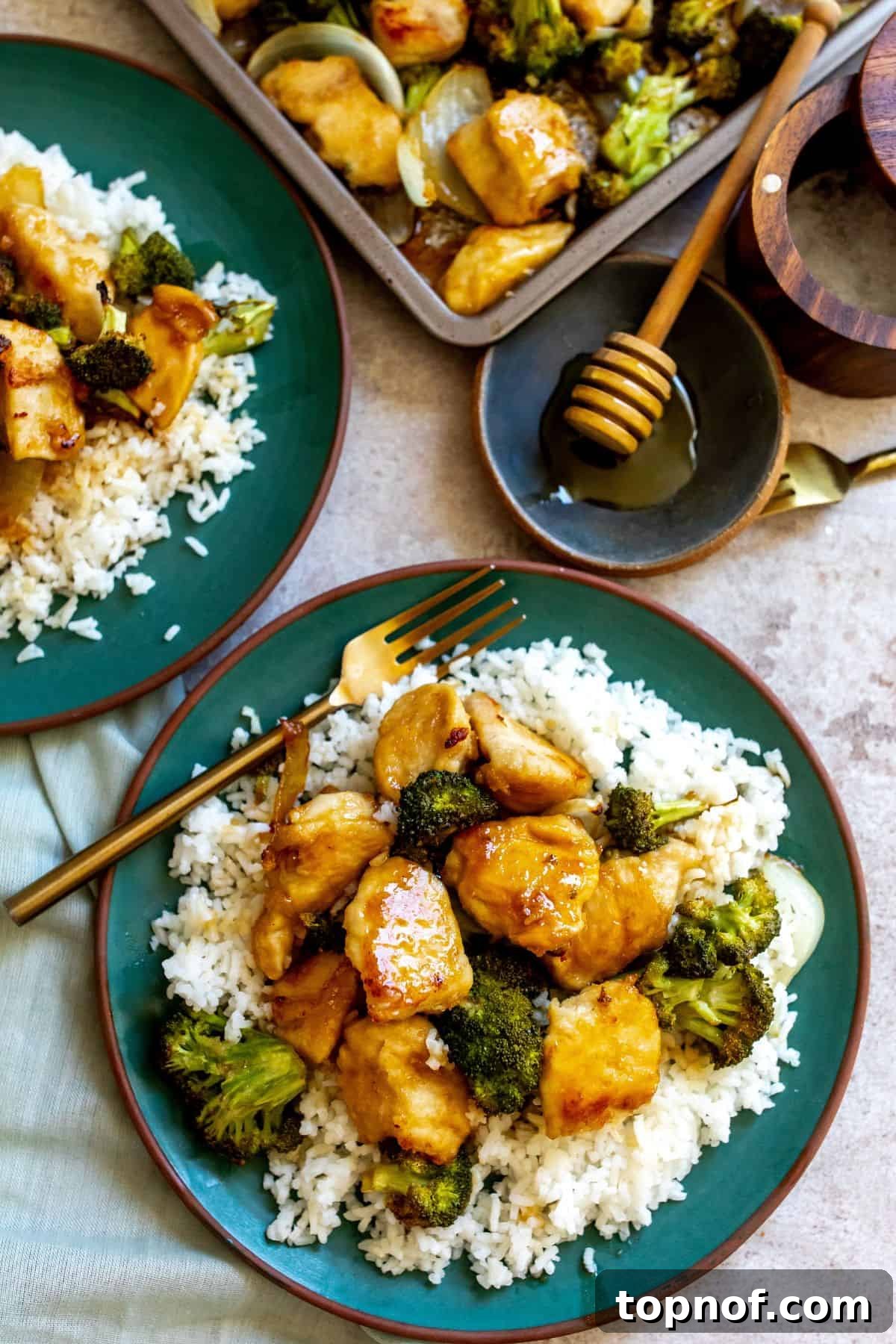 One-Pan Honey Butter Glazed Chicken 2 Chicken with honey butter sauce on a green plate with rice.