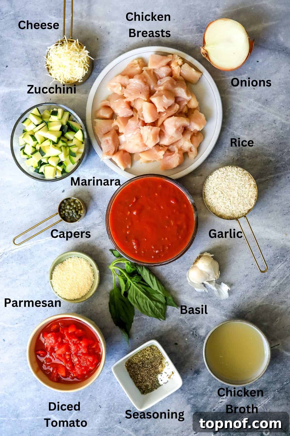 Savory Chicken Tomato Bake 3 All the ingredients needed to make this recipe on a counter in bowls and plates. A beautifully arranged collection of all the fresh and pantry ingredients required for the chicken and tomato casserole, displayed neatly in various bowls and plates on a kitchen counter, ready for preparation.