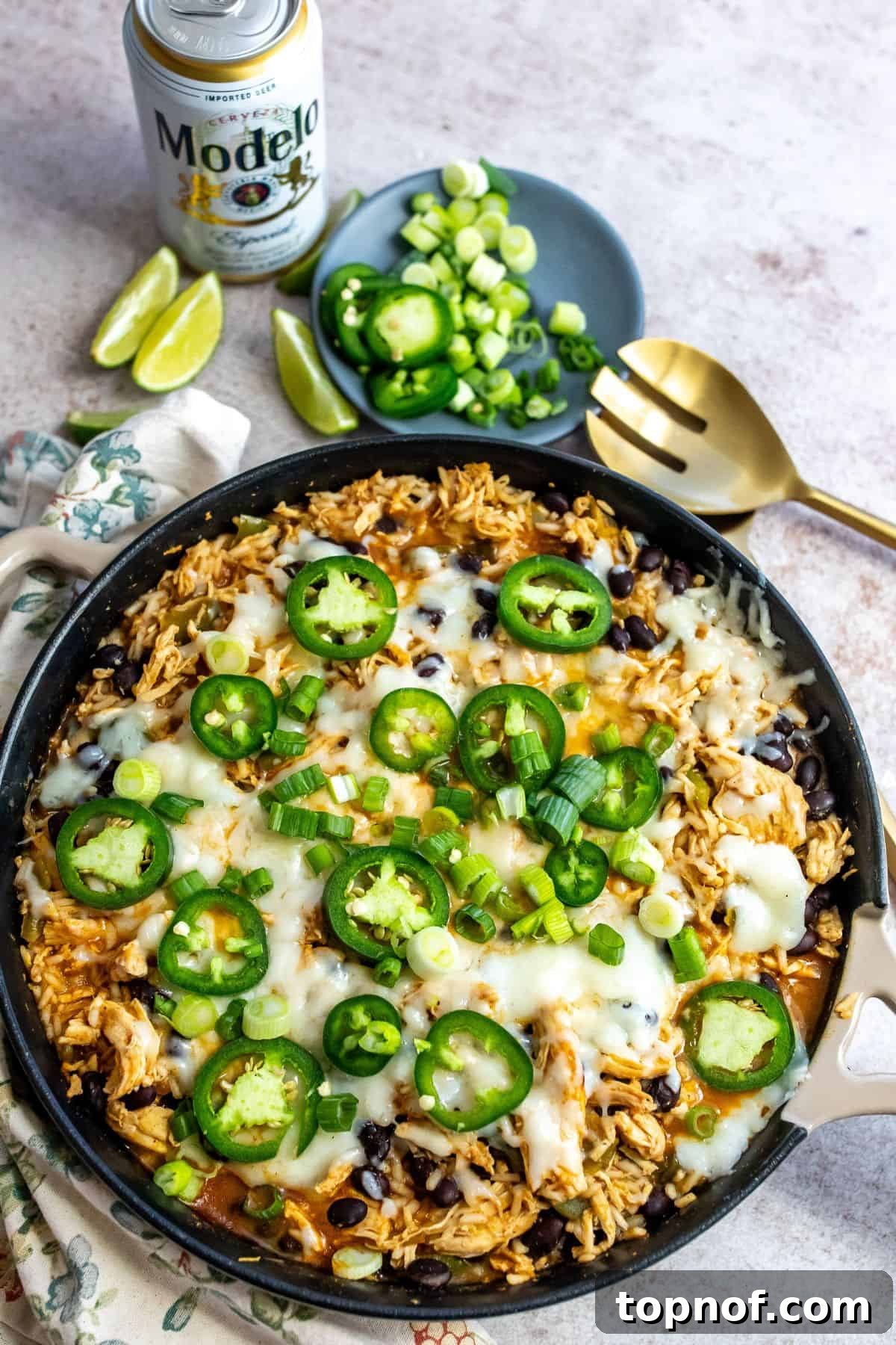 One-Pan Southwest Chicken Fiesta 2 A vibrant cast iron skillet filled with savory Southwest chicken, fluffy rice, melted cheese, and fresh jalapeños, ready to be served.