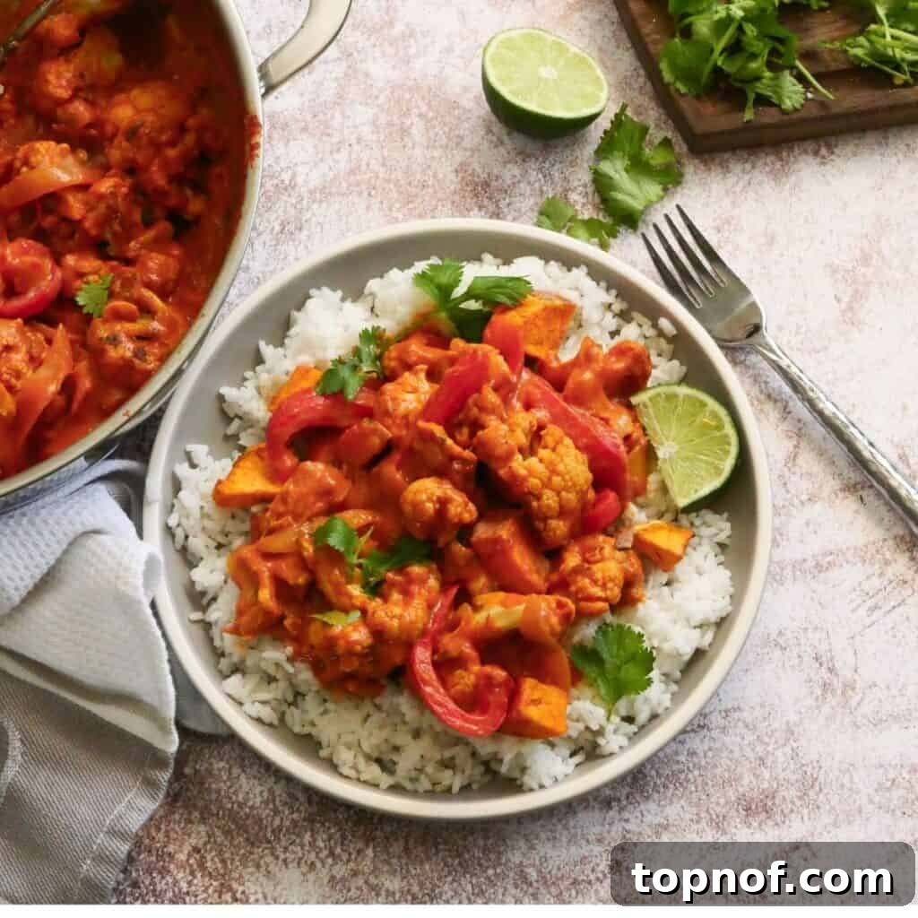 Spiced Cauliflower and Potato Curry 2 Delicious Cauliflower Sweet Potato Curry in a serving bowl, garnished with fresh cilantro.