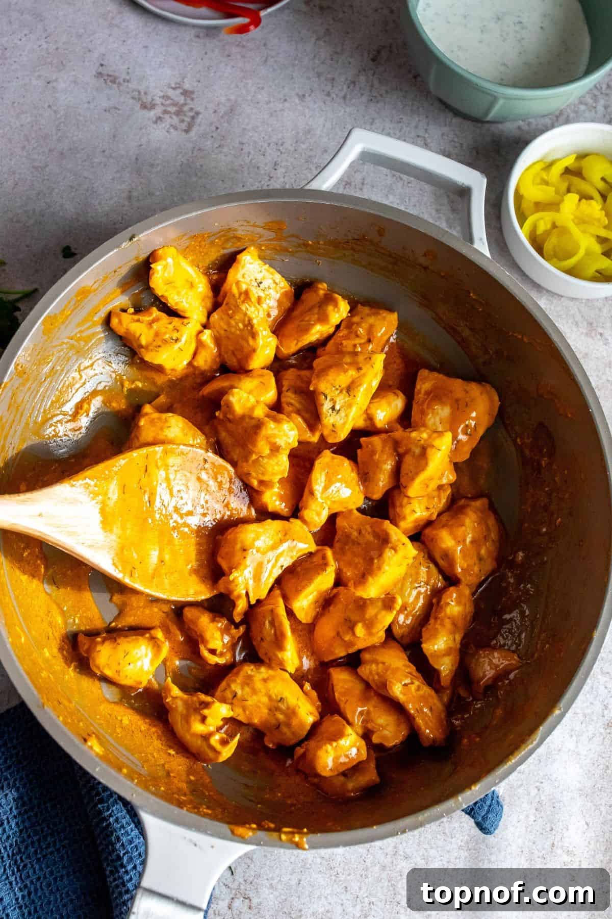 Zesty Buffalo Chicken Power Bowl 5 Ingredients for homemade ranch dressing, including sour cream, herbs, and apple cider vinegar, prepared in small bowls on a counter.